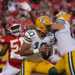 
              Green Bay Packers quarterback Jordan Love (10) drops back to pass under pressure from Kansas City Chiefs defensive end Mike Danna (51) during the first half of an NFL preseason football game Thursday, Aug. 25, 2022, in Kansas City, Mo. (AP Photo/Ed Zurga)
            