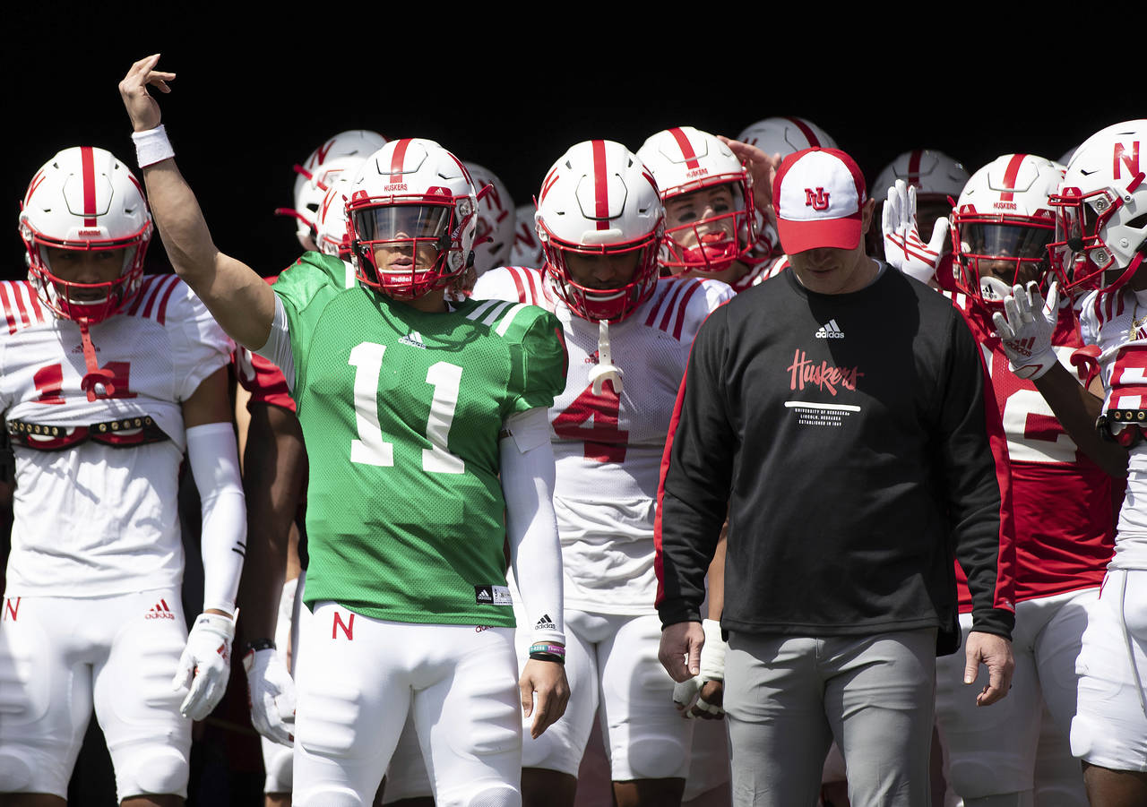 FILE - Nebraska red team quarterback Casey Thompson (11) signals the crowd before leading both the ...