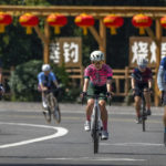 
              Members of the Qiyi bicycle club ride along a rural road during a group ride through the Baihe River Canyon in the northern outskirts of Beijing, Wednesday, July 13, 2022. Cycling has gained increasing popularity in China as a sport. A coronavirus outbreak that shut down indoor sports facilities in Beijing earlier this year encouraged people to try outdoor sports including cycling. (AP Photo/Mark Schiefelbein)
            