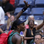 
              Venus Williams, of the United States, waves to fans as she walks off the court after losing to Alison Van Uytvanck, of Belgium, during the first round of the US Open tennis championships, Tuesday, Aug. 30, 2022, in New York. (AP Photo/Seth Wenig)
            