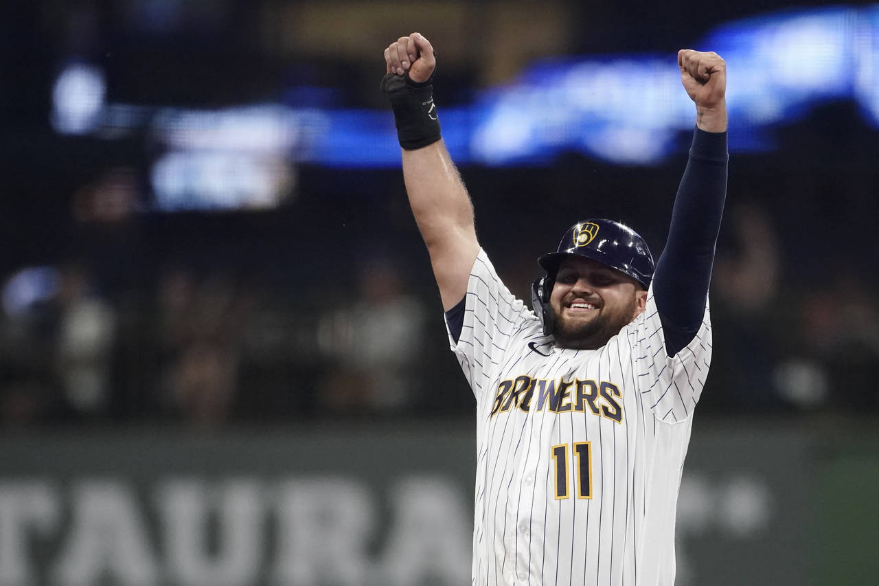 Milwaukee Brewers' Rowdy Tellez gestures to the dugout after stealing second base during the third ...