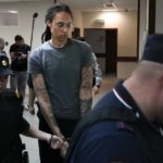 
              WNBA star and two-time Olympic gold medalist Brittney Griner, center, is escorted in a court room prior to a hearing, in Khimki just outside Moscow, Russia, Thursday, Aug. 4, 2022. Closing arguments in Brittney Griner's cannabis possession case are set for Thursday, nearly six months after the American basketball star was arrested at a Moscow airport in a case that reached the highest levels of US-Russia diplomacy. (AP Photo/Alexander Zemlianichenko)
            