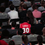
              Students and fans watch as Golden State Warriors Stephen Curry gets his number and jersey retired at Davidson College on Wednesday, Aug. 31, 2022, in Davidson, N.C. Curry was also inducted into the school's Hall of Fame and had his graduation ceremony. (AP Photo/Chris Carlson)
            