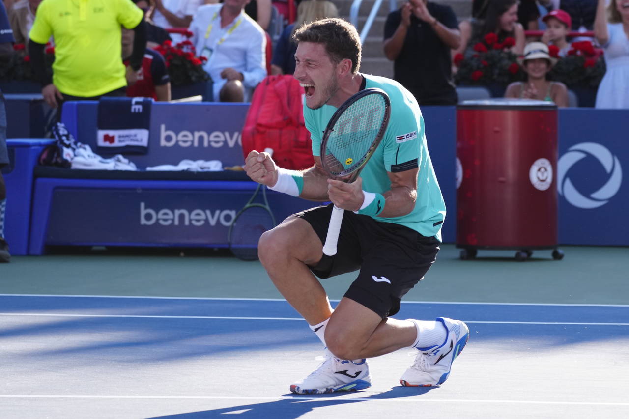 Pablo Carreno Busta, of Spain, reacts after defeating Hubert Hurkacz, of Poland, to win the final o...