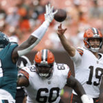 
              Cleveland Browns quarterback Josh Rosen (19) passes the ball as Philadelphia Eagles defensive tackle Renell Wren (98) applies pressure during the second half of an NFL preseason football game in Cleveland, Sunday, Aug. 21, 2022. (AP Photo/Ron Schwane)
            