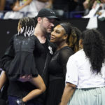 
              Serena Williams, of the United States, talks with her husband Alexis Ohanian and daughter Olympia after defeating Danka Kovinic, of Montenegro, during the first round of the US Open tennis championships, Monday, Aug. 29, 2022, in New York. (AP Photo/John Minchillo)
            