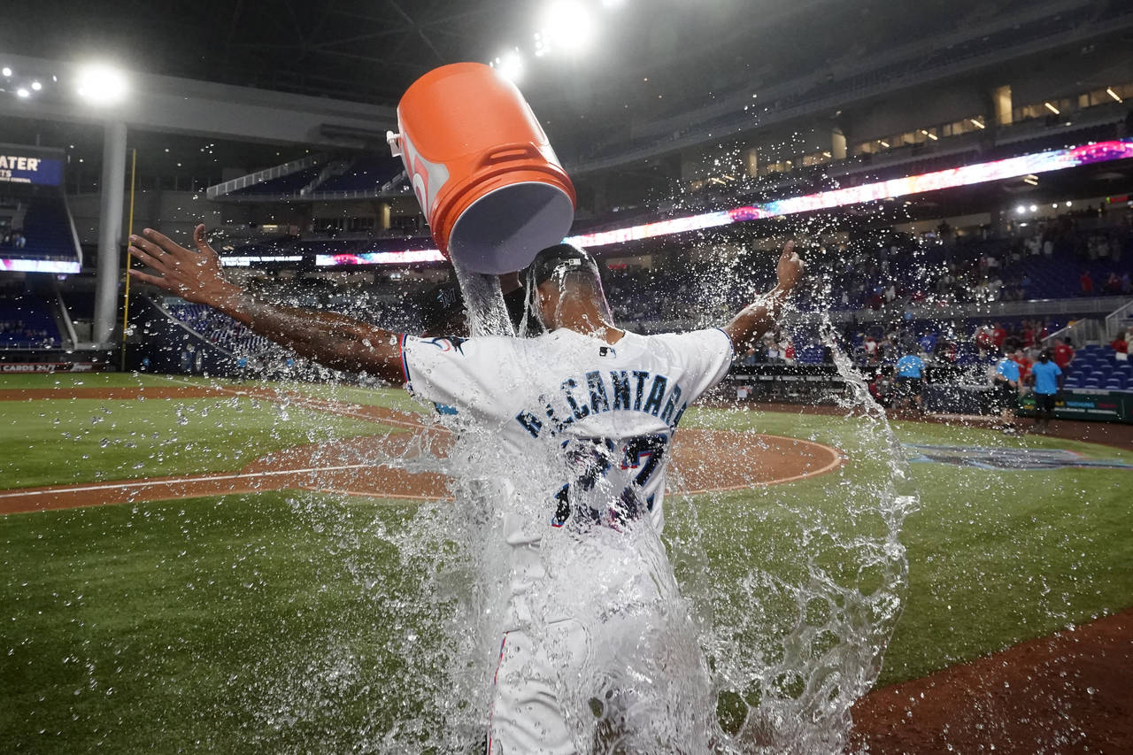 Miami Marlins starting pitcher Sandy Alcantara is doused by Pablo Lopez after the Marlins beat the ...