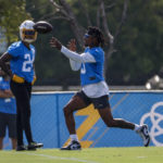 
              Los Angeles Chargers safeties Derwin James Jr., right, throws a ball as Nasir Adderley (24) looks on during the NFL football team's training camp, Wednesday, July 27, 2022, in Costa Mesa, Calif. (AP Photo/Ringo H.W. Chiu)
            