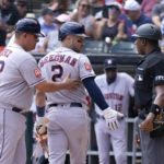 
              Houston Astros first base coach Omar Lopez (22) guides Alex Bregman to the dugout as Bregman has words with home plate umpire Jesus, Ramon, after Ramon called Bregman out on strikes during the first inning of a baseball game against the Chicago White Sox Thursday, Aug. 18, 2022, in Chicago. (AP Photo/Charles Rex Arbogast)
            