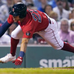 
              Boston Red Sox's Tommy Pham dives home to score on a double by Rafael Devers during the third inning of a baseball game against the Toronto Blue Jays, Thursday, Aug. 25, 2022, in Boston. (AP Photo/Charles Krupa)
            