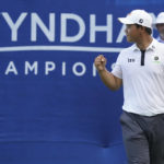 
              Joohyoung Kim, right, of South Korea, reacts after winning the Wyndham Championship golf tournament in Greensboro, N.C., Sunday, Aug. 7, 2022. (AP Photo/Chuck Burton)
            