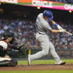 
              Los Angeles Dodgers' Will Smith, right, hits an RBI double in front of San Francisco Giants catcher Joey Bart during the fifth inning of a baseball game in San Francisco, Monday, Aug. 1, 2022. (AP Photo/Jeff Chiu)
            