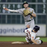
              Oakland Athletics second baseman Nick Allen, top, turns a double play against Houston Astros' Martin Maldonado after forcing out Chas McCormick, bottom, during the sixth inning of a baseball game Saturday, Aug. 13, 2022, in Houston. (AP Photo/Kevin M. Cox)
            
