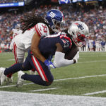 
              New York Giants cornerback Aaron Robinson (33) brings down New England Patriots wide receiver Kristian Wilkerson during the first half of a preseason NFL football game Thursday, Aug. 11, 2022, in Foxborough, Mass. (AP Photo/Michael Dwyer)
            