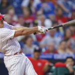 
              Philadelphia Phillies' J.T. Realmuto hits a two-run home run during the third inning of the team's baseball game against the Washington Nationals, Friday, Aug. 5, 2022, in Philadelphia. (AP Photo/Chris Szagola)
            