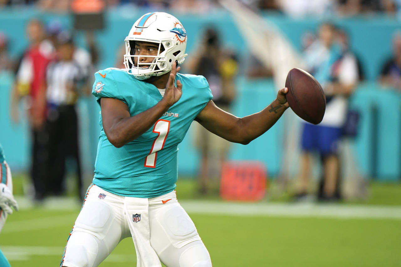 Miami Dolphins quarterback Tua Tagovailoa (1) aims a pass during the first half of a NFL preseason ...