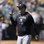 
              New York Yankees manager Aaron Boone walks to the dugout after making a pitching change during the fifth inning of his team's baseball game against the Oakland Athletics in Oakland, Calif., Sunday, Aug. 28, 2022. (AP Photo/Jeff Chiu)
            