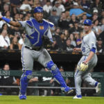 
              Kansas City Royals catcher Salvador Perez throws out Chicago White Sox's Tim Anderson at first as relief pitcher Dylan Coleman watches during the seventh inning of a baseball game Monday, Aug. 1, 2022, in Chicago. (AP Photo/Charles Rex Arbogast)
            