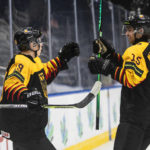 
              Germany's Haakon Hanelt (19) and Luca Munzenberger (15) celebrate a goal against Switzerland during the second period of an IIHF world junior hockey championships game in Edmonton, Alberta, Saturday, Aug. 13, 2022. (Jason Franson/The Canadian Press via AP)
            