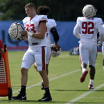 
              Tampa Bay Buccaneers linebacker Carl Nassib (93) puts his helmet on before taking part in drills during a combined NFL football training camp with the Tennessee Titans Wednesday, Aug. 17, 2022, in Nashville, Tenn. (AP Photo/Mark Zaleski)
            