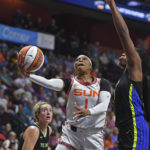 
              Connecticut Sun guard Odyssey Sims (1) drives by Dallas Wings center Teaira McCowan (7) during Game 1 of a WNBA basketball first-round playoff series Thursday, Aug. 18, 2022, in Uncasville, Conn. (Sean D. Elliot/The Day via AP)
            