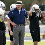 
              FILE - Odessa Permian head coach Gary Gaines, center, watches his high school football players work out in Odessa, Texas, May 21, 2009. Gaines, coach of the Texas high school football team made famous in the book and movie “Friday Night Lights,” has died. He was 73. Gaines’ family says the former coach died in Lubbock after a long battle with Alzheimer’s disease. (AP Photo/Kevin Buehler, File)
            