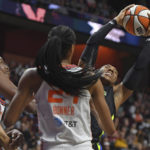 
              Dallas Wings forward Kayla Thornton wins the rebounding battle with Connecticut Sun forward Jonquel Jones and forward DeWanna Bonner in Game 2 of a WNBA basketball first-round playoff series, Sunday, Aug. 21, 2022, in Uncasville, Conn. (Sean D. Elliot/The Day via AP)
            