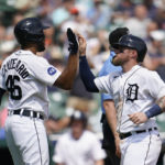 
              Detroit Tigers' Jeimer Candelario (46) and Tucker Barnhart celebrate scoring against the San Francisco Giants in the fifth inning of a baseball game in Detroit, Wednesday, Aug. 24, 2022. (AP Photo/Paul Sancya)
            