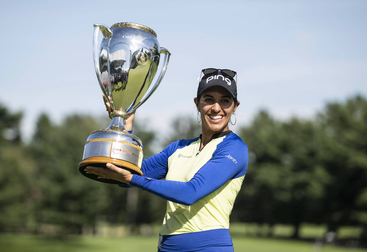 Paula Reto, of South Africa, holds the trophy after winning the the Canadian Pacific Women's Open g...