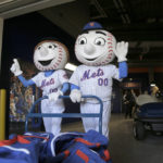 
              FILE - New York Mets mascots Mr. and Mrs. Met pose for pictures with the team's equipment before it is sent to spring training, at Citi Field in New York, Monday, Feb. 4, 2019. New York's Edwin Díaz has become baseball's most dominant closer this year and turned into the toast of the town with the Mets. Part of Díaz’s newfound popularity in Queens is his catchy entrance song “Narco” by Blasterjaxx & Timmy Trumpet. The tune sets off a two-minute fiesta all around Citi Field, with dancing mascots Mr. and Mrs. Met pretending to play trumpets as Díaz warms up on the mound. (AP Photo/Seth Wenig, File)
            