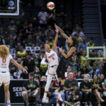 
              Seattle Storm forward Gabby Williams (5) shoots over Washington Mystics guard Natasha Cloud (9) during the first half of Game 1 of a WNBA basketball first-round playoff series Thursday, Aug. 18, 2022, in Seattle. (AP Photo/Lindsey Wasson)
            