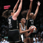 
              New York Liberty center Stefanie Dolson (31) and New York Liberty forward Betnijah Laney (44) defend against Chicago Sky forward Candace Parker during the first half of a WNBA basketball playoff game Tuesday, Aug. 23, 2022, in New York. (AP Photo/Noah K. Murray)
            