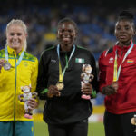 
              Silver medalist Brooke Buschkuehl of Australia, gold medalist Ese Brume of Nigeria and bronze medalist Deborah Acquah of Ghana, from left to right, pose with their medals on the podium of the Women's long jump final during the athletics competition in the Alexander Stadium at the Commonwealth Games in Birmingham, England, Sunday, Aug. 7, 2022. (AP Photo/Alastair Grant)
            