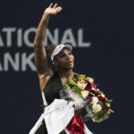 
              Serena Williams, of the United States, leaves the court carrying flowers and waving to fans after her loss to Belinda Bencic, of Switzerland, during the National Bank Open tennis tournament Wednesday, Aug. 10, 2022, in Toronto. (Chris Young/The Canadian Press via AP)
            