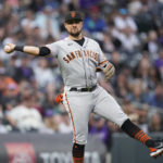 
              San Francisco Giants third baseman J.D. Davis throws to first base to put out Colorado Rockies' Brian Serven in the third inning of a baseball game against the Saturday, Aug. 20, 2022, in Denver. (AP Photo/David Zalubowski)
            
