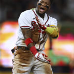 
              Atlanta Braves outfielder Ronald Acuna yells after sliding into second base for an RBI double against the New York Mets during the fourth inning of a baseball game Monday, Aug, 15, 2022, in Atlanta. (Curtis Compton//Atlanta Journal-Constitution via AP)
            