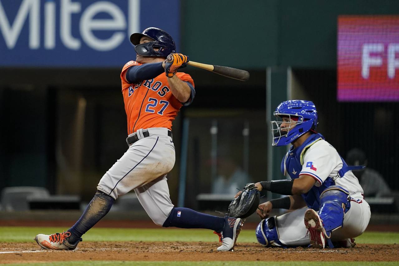Houston Astros' Jose Altuve follows through on a two RBI double in the second inning of a baseball ...