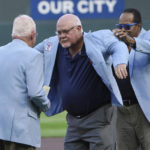
              Former Minnesota Twins manger Ron Gardenhire, center, receives a coat from his predecessor, former manager Tom Kelly, as Twins great Rod Carew. Right, helps putting it on Gardenhire after he was inducted into the Twins Hall of Fame prior to the Twins' baseball game against the Texas Rangers, Saturday, Aug, 20, 2022, in Minneapolis. (AP Photo/Jim Mone0
            