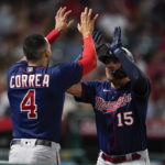 
              Minnesota Twins' Gio Urshela (15) celebrates with Carlos Correa (4) after hitting a home run during the sixth inning of a baseball game against the Los Angeles Angels in Anaheim, Calif., Friday, Aug. 12, 2022. (AP Photo/Ashley Landis)
            