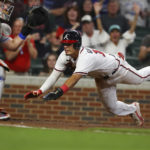 
              Atlanta Braves' Vaughn Grissom, right goes home past New York Mets catcher James McCann, left, to score the winning run on an RBI-single by Michael Harris during the seventh inning of a baseball game Thursday, Aug. 18, 2022, in Atlanta. (Curtis Compton/Atlanta Journal-Constitution via AP)
            