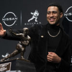 
              FILE - Alabama quarterback Bryce Young poses for a photograph after winning the Heisman Trophy, Saturday, Dec. 11, 2021, in New York. Young is again a top contender for the 2022 Heisman Trophy. (AP Photo/John Minchillo, File)
            