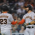 
              San Francisco Giants' Evan Longoria celebrates with Joc Pederson (23) after hitting a two-run home run against the Detroit Tigers in the sixth inning of a baseball game in Detroit, Tuesday, Aug. 23, 2022. (AP Photo/Paul Sancya)
            