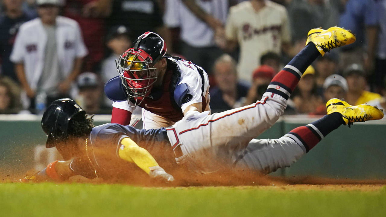 Atlanta Braves' Ronald Acuna Jr. beats the tag by Boston Red Sox catcher Kevin Plawecki to score on...