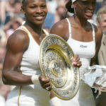 
              FILE - Serena Williams, left, holds her trophy after defeating her sister Venus, right, to win the women's singles final on the Centre Court at Wimbledon, Saturday, July 6, 2002. Serena won the match 7-6 (7-4), 6-3. Saying “the countdown has begun,” 23-time Grand Slam champion Serena Williams announced Tuesday, Aug. 9, 2022, she is ready to step away from tennis so she can turn her focus to having another child and her business interests, presaging the end of a career that transcended sports. (AP Photo/Ted S. Warren, File)
            