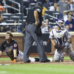 
              New York Mets' Jeff McNeil reacts as Colorado Rockies catcher Elias Diaz watches after McNeil is called out at home by umpire Hunter Wendelstedt (21) during the sixth inning of a baseball game on Friday, Aug. 26, 2022, in New York. (AP Photo/Jessie Alcheh)
            