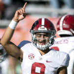 
              FILE - Alabama quarterback Bryce Young (9) during warm ups before the start of an NCAA college football game against Auburn Saturday, Nov. 27, 2021, in Auburn, Ala. Alabama is No. 1 in the preseason AP Top 25 for the second straight season. (AP Photo/Butch Dill, File)
            