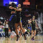 
              Dallas Wings forward Satou Sabally celebrates with Allisha Gray (15) after Sabally hit a half-court shot at the end of the first quarter against the Connecticut Sun during Game 1 of a WNBA basketball first-round playoff series Thursday, Aug. 18, 2022, in Uncasville, Conn. (Sean D. Elliot/The Day via AP)
            