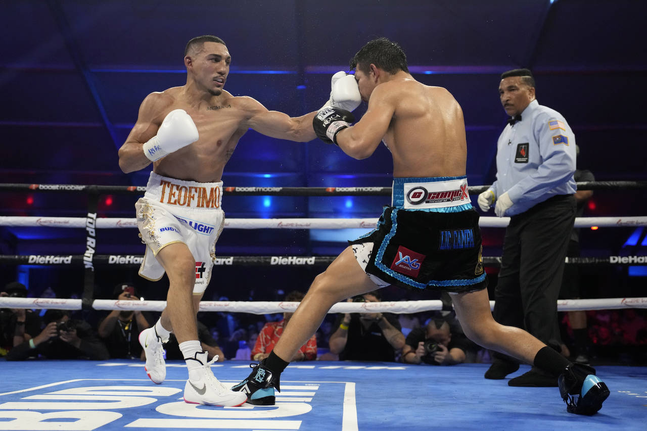 Teofimo Lopez hits Pedro Campa in a junior welterweight boxing match, Saturday, Aug. 13, 2022, in L...