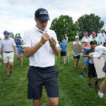 
              Jordan Spieth signs autographs as he walks back to the clubhouse during a weather stoppage in the ProAm at the BMW Championship golf tournament at Wilmington Country Club, Wednesday, Aug. 17, 2022, in Wilmington, Del. The BMW Championship tournament begins on Thursday. (AP Photo/Julio Cortez)
            