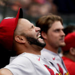 
              St. Louis Cardinals' Albert Pujols laughs in the dugout during the eighth inning of a baseball game against the Chicago Cubs Thursday, Aug. 25, 2022, in Chicago. (AP Photo/Charles Rex Arbogast)
            